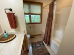 Loft bathroom offers a tub shower combo 